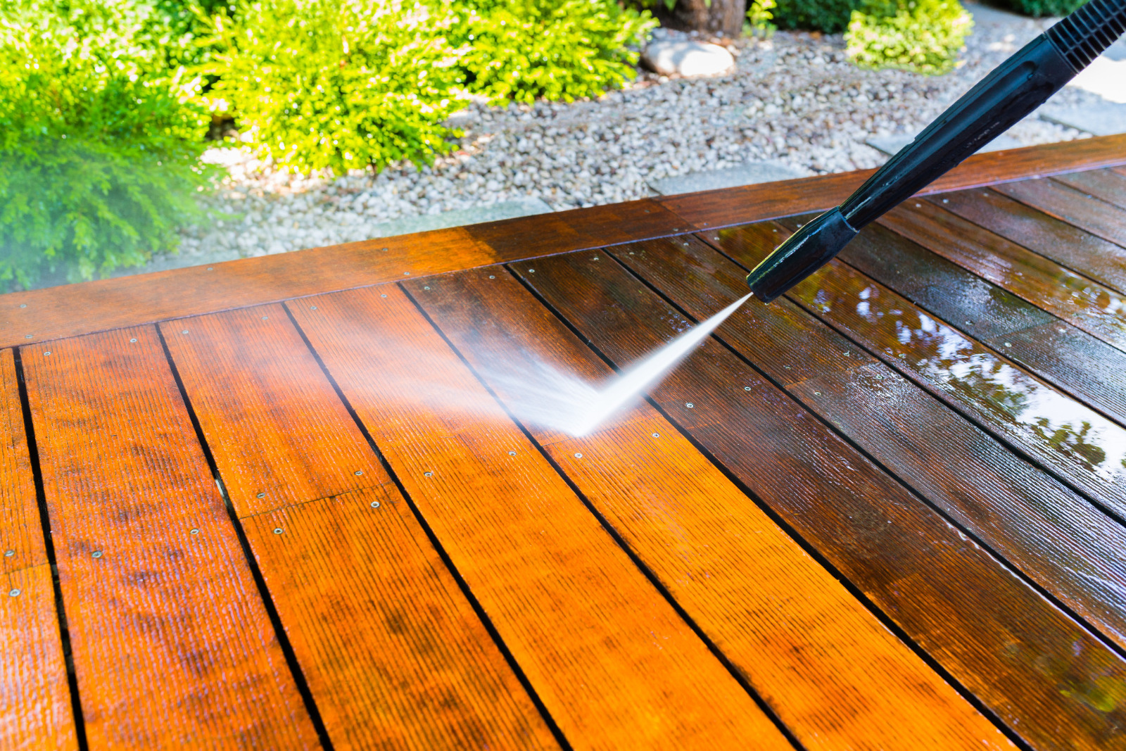 Pressure washing hardwood garden decking before Deck Sanding in South Woodford, cleaning the outdoor wooden floorboards ready for restoration.