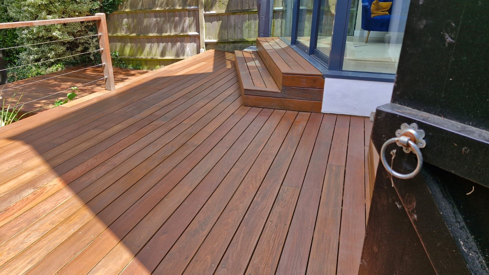 Freshly restored hardwood timber garden decking and steps after Deck Sanding in South Woodford, showing a smooth, even outdoor floor finish.